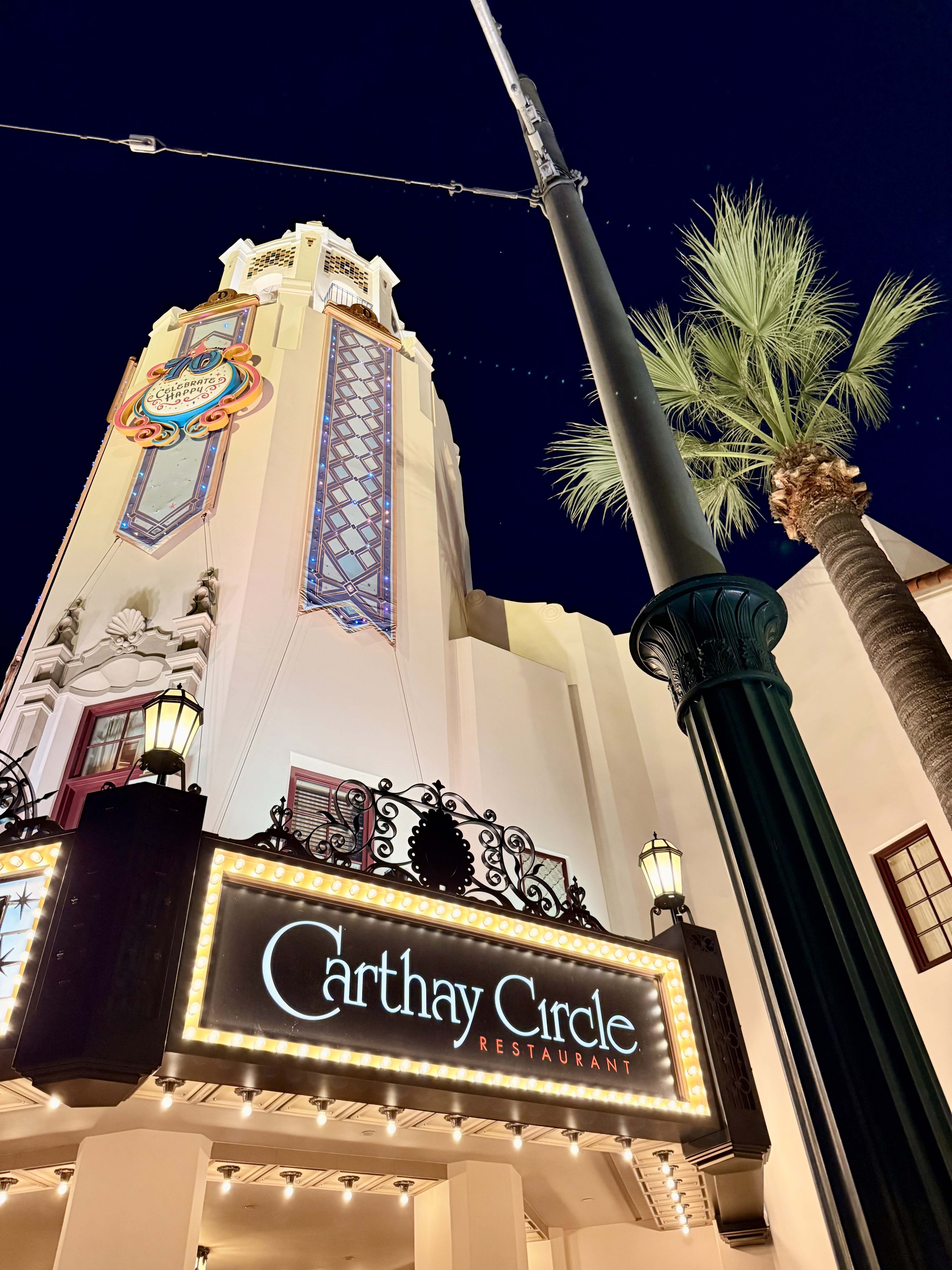 Ornate illuminated facade of the Carthay Circle restaurant at night