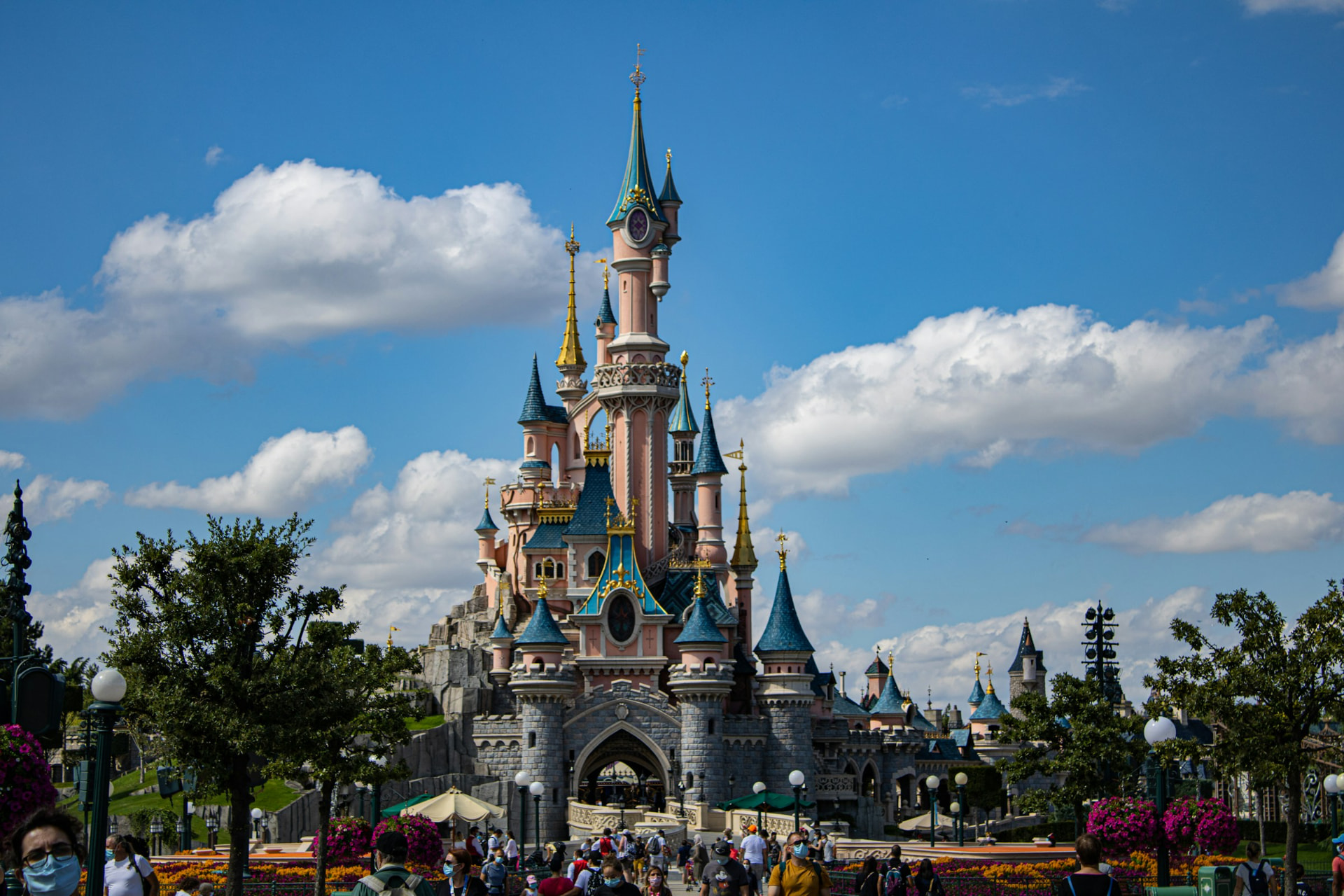 Sleeping Beauty Castle at Disneyland Paris under a bright blue sky